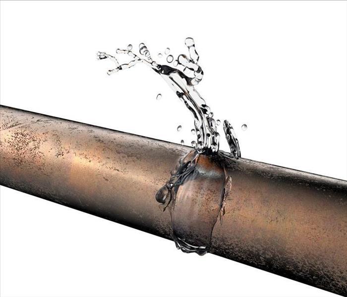 Image of a bursted pipe leaking water.