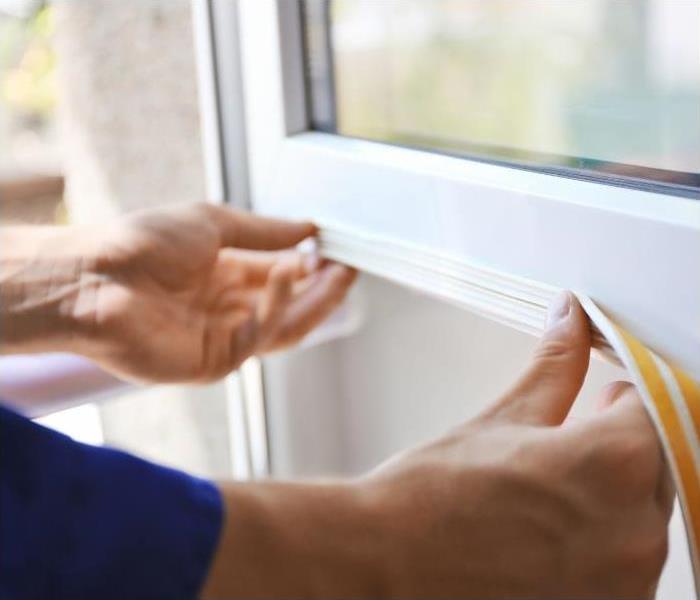 Professional sealing and insulating a window.